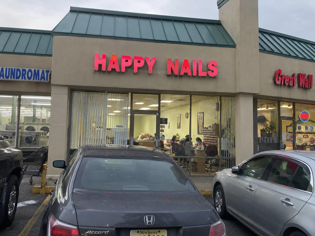 Happy Nails storefront with the salon visible through the windows