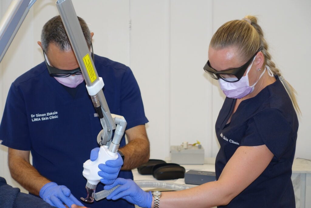 Practitioners using treatment equipment at LINIA Skin Clinic