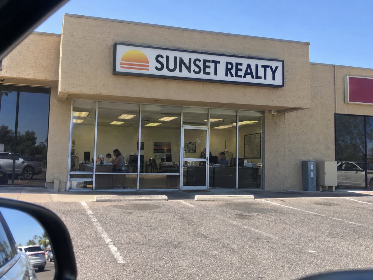 Sunset Realty office storefront with the business sign above the entrance